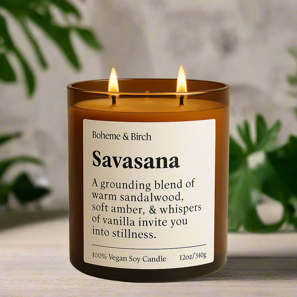 Scented candle labeled 'Savasana' by Boheme & Birch on a beige background with decorative elements.