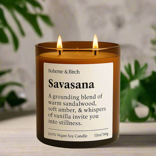 Scented candle labeled 'Savasana' by Boheme & Birch on a beige background with decorative elements.